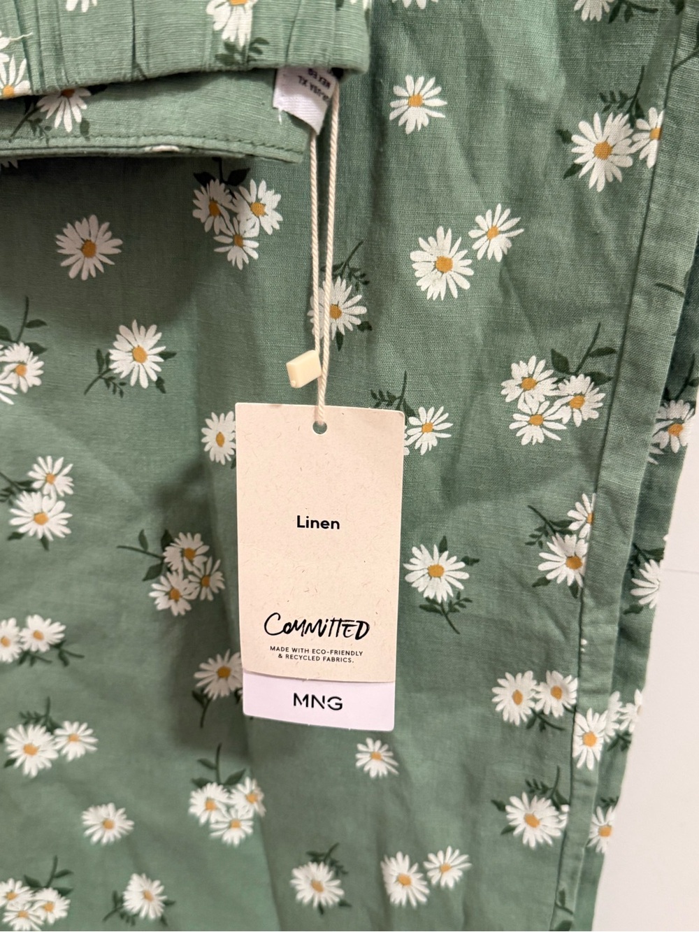 Mango Green Floral Linen wide leg pants. It has two pockets.